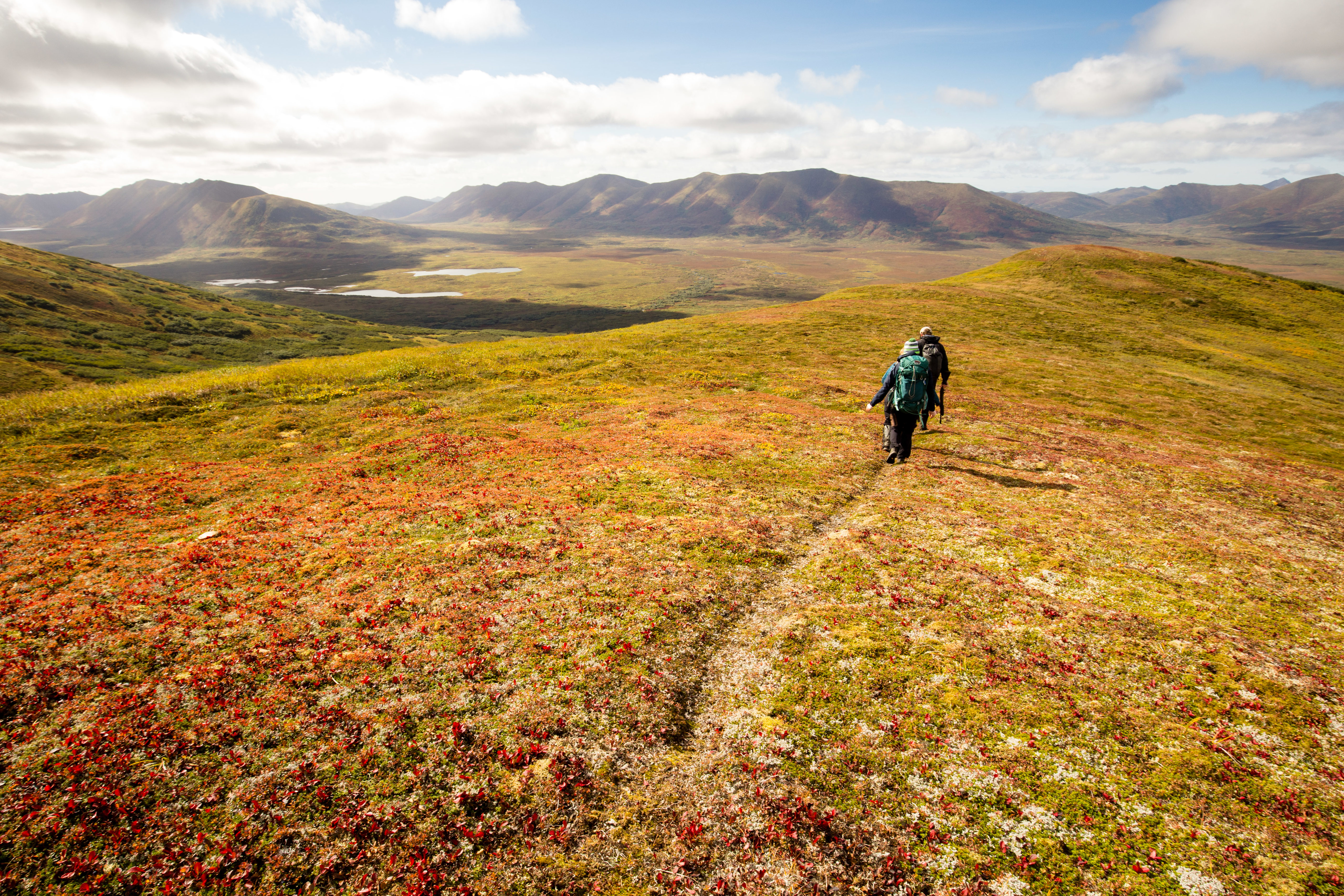 Two hikers on a ridge in Alaska