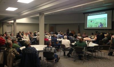 room full of people watching presentation