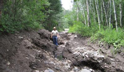 Road washed out due to extreme precipitation.