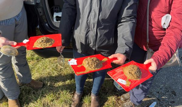 After sitting in water for about a minute, the strainers are overturned onto a flat surface.  The conventionally tilled soil on the far left did not hold its shape, indicating low aggregate stability and likely less biological activity. The soil that held its shape the best was the no-till soil on the far right.