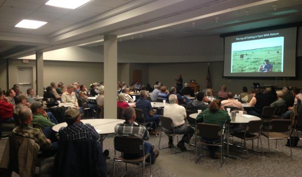 room full of people watching presentation